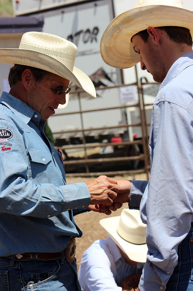 Rick Foster Justin Sports Medicine examing a patient at a rodeo.