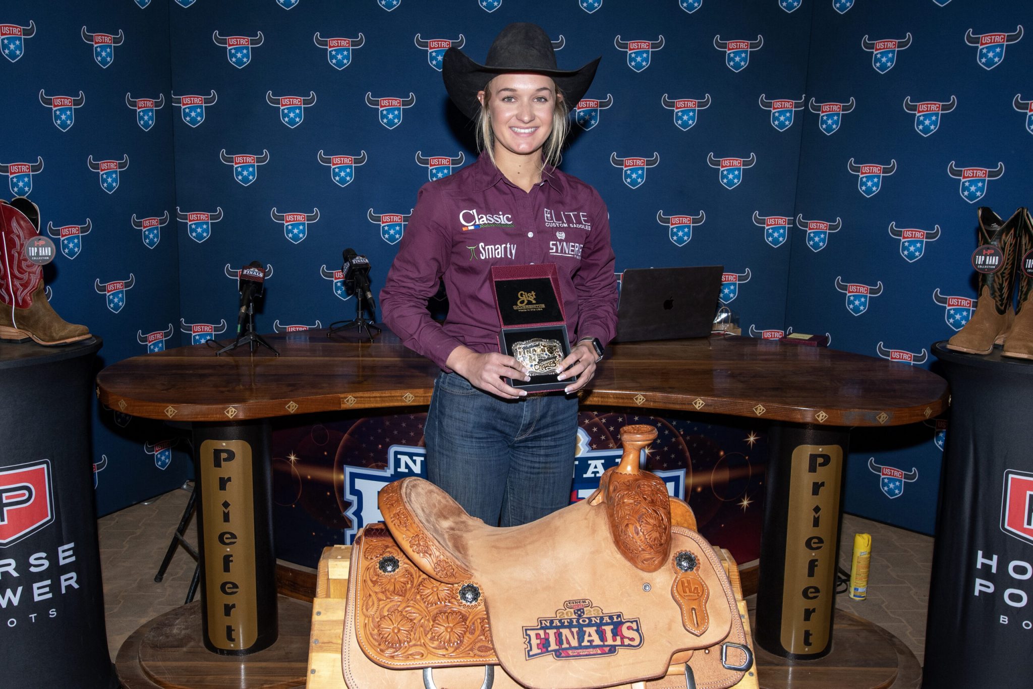Quincy Sullivan poses with her breakaway roping awards at the USTRC finals.