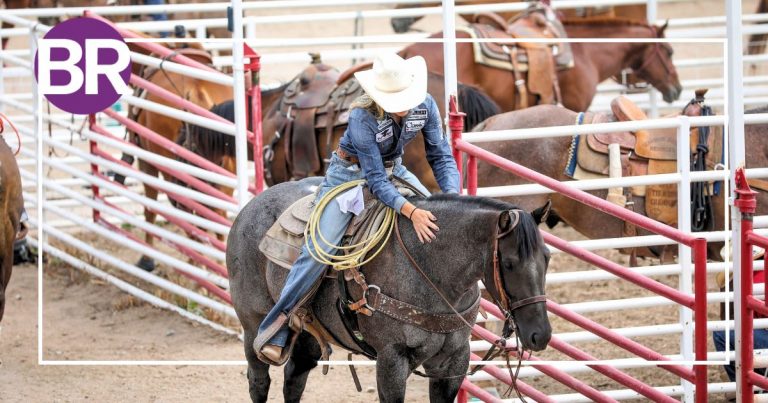 A breakaway roper pets her horse at the Calgary Stampede rodeo
