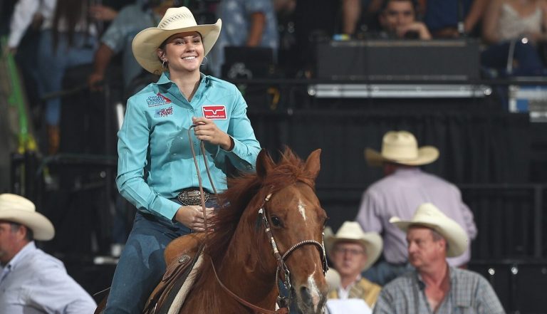 Kerstin Freeman was all smiles after roping her Progressive Round calf in 1.74 seconds. Image courtesy WCRA by Bull Stock Media.