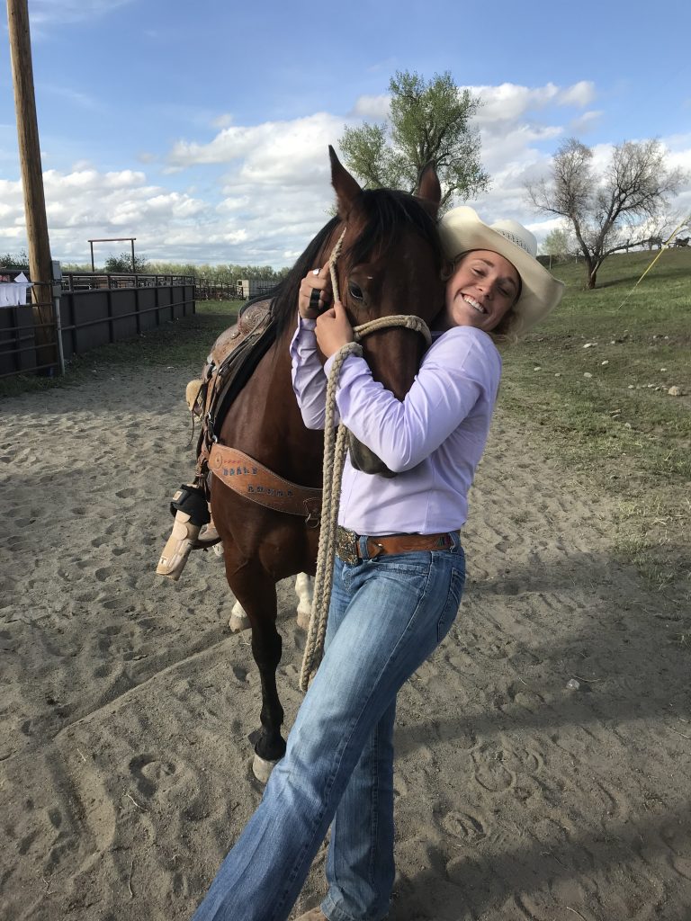 Taylor Munsell hugs her breakaway horse, Monster