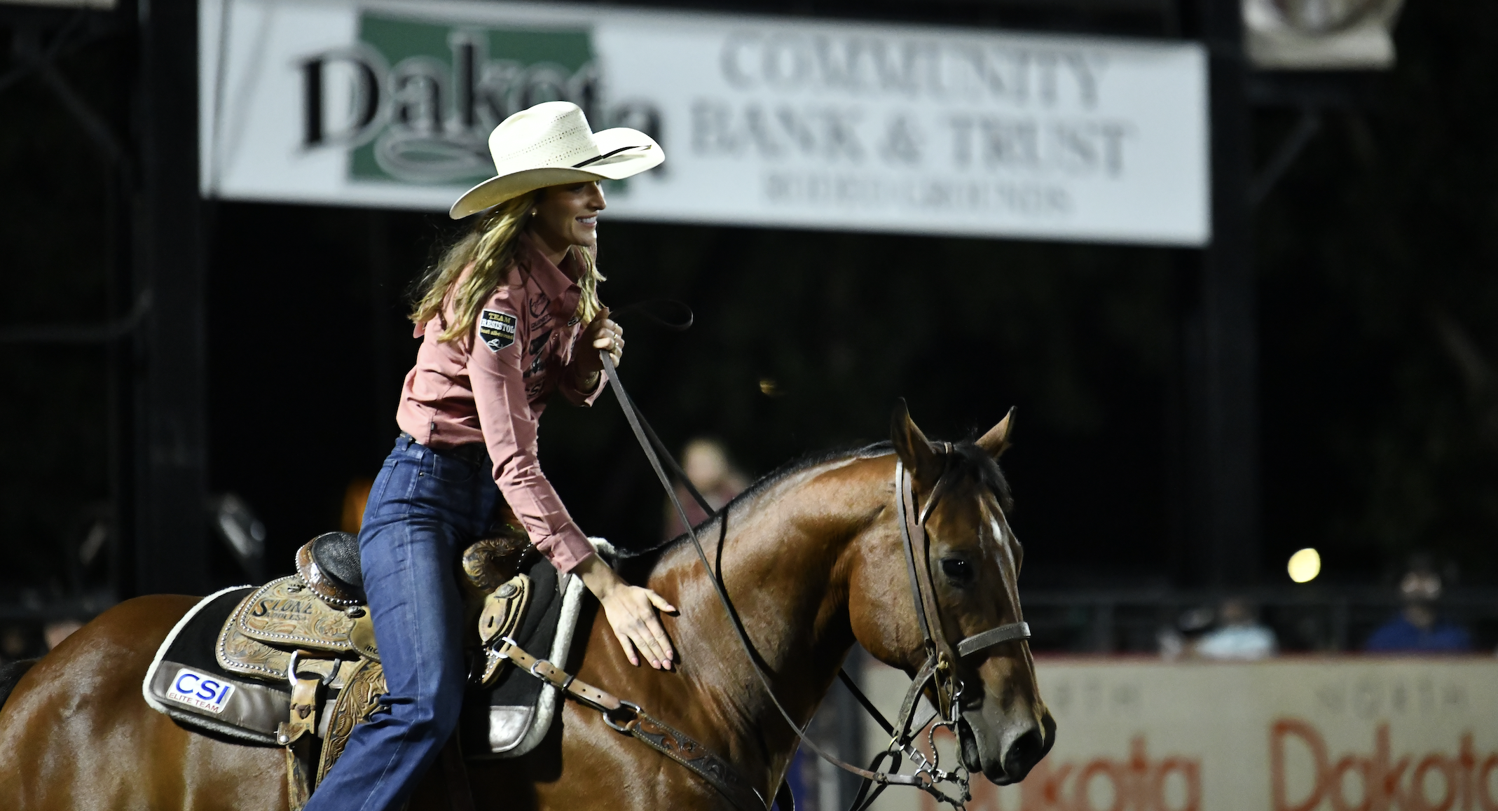 Kinlie Brennise rides out of the muddy arena in North Dakota after a successful run on "Rio."